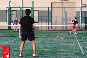Practicing tennis